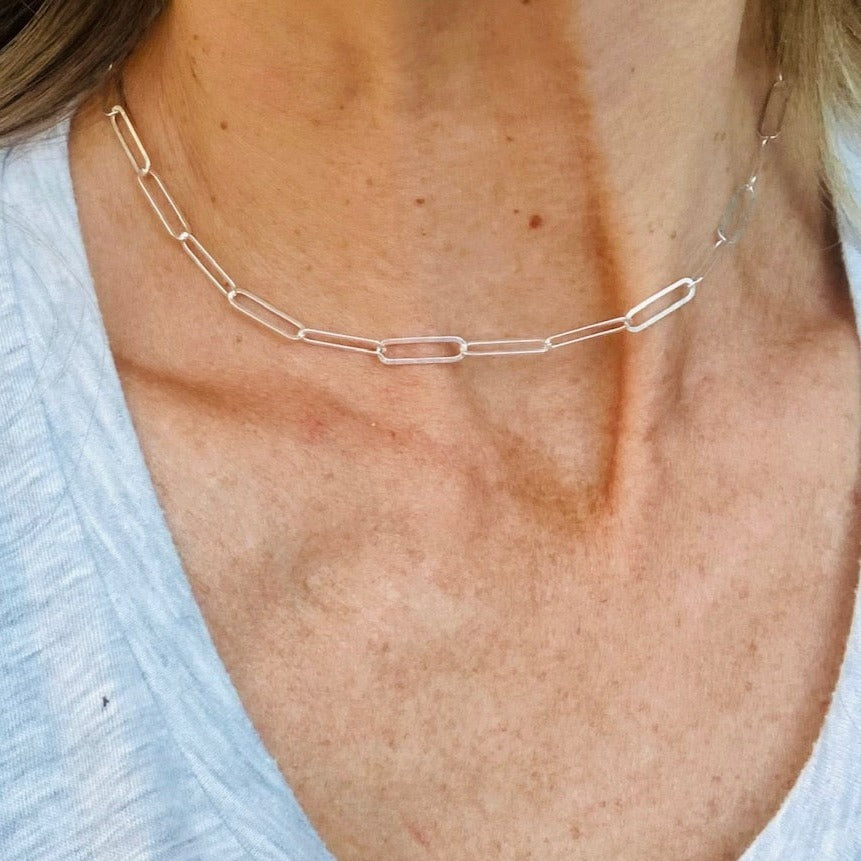 This version of a paperclip chain is a sterling silver oval cable chain with a sleek toggle clasp also sterling silver.