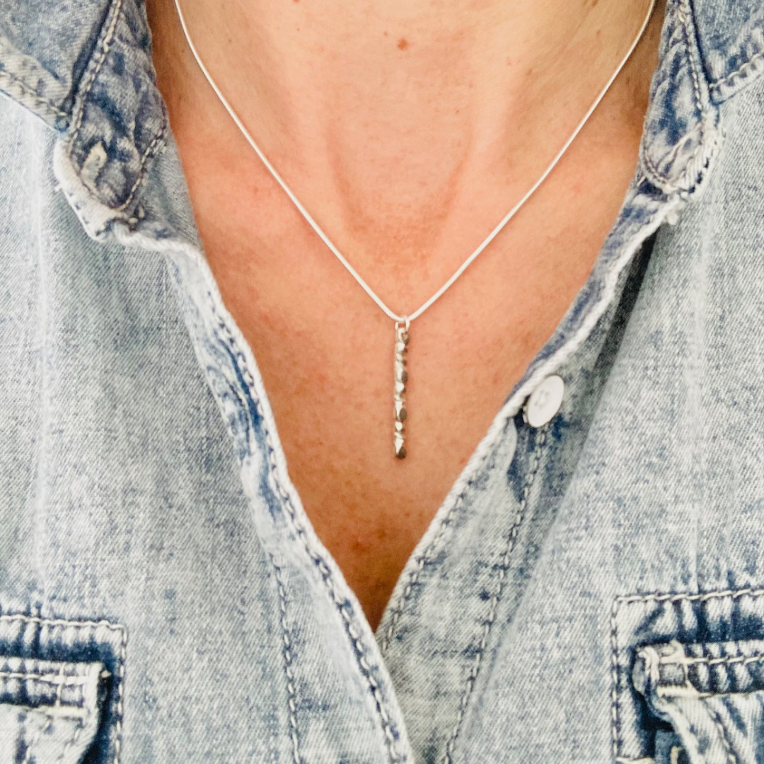 The sterling silver 1" bar is a handcarved fortenna™ design providing texture and visual detail. Tumbled for a lightly polished look. Comes on adjustable 16-18" sterling silver snake chain.