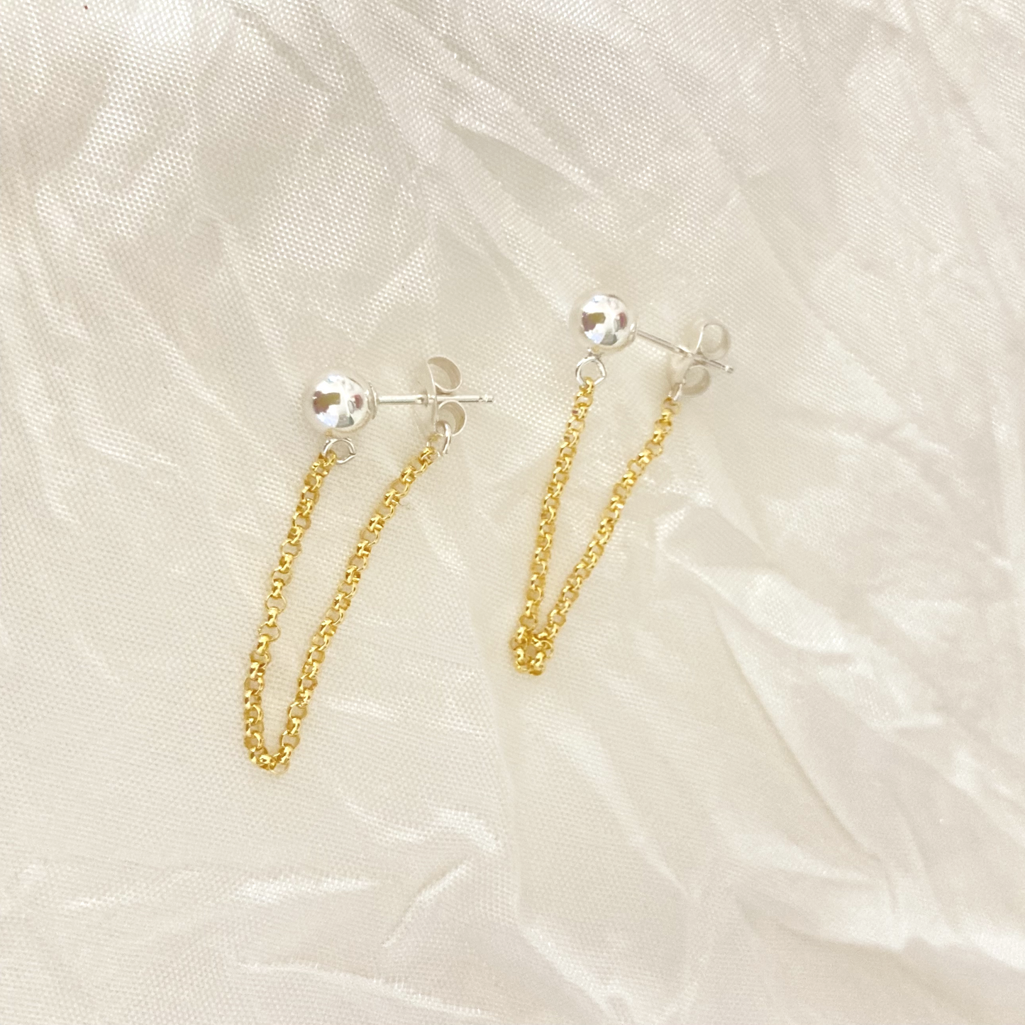 A delicate 14k gold-filled chain contrasts with these classic sterling silver ball post earrings for a sleek mixed metals look.