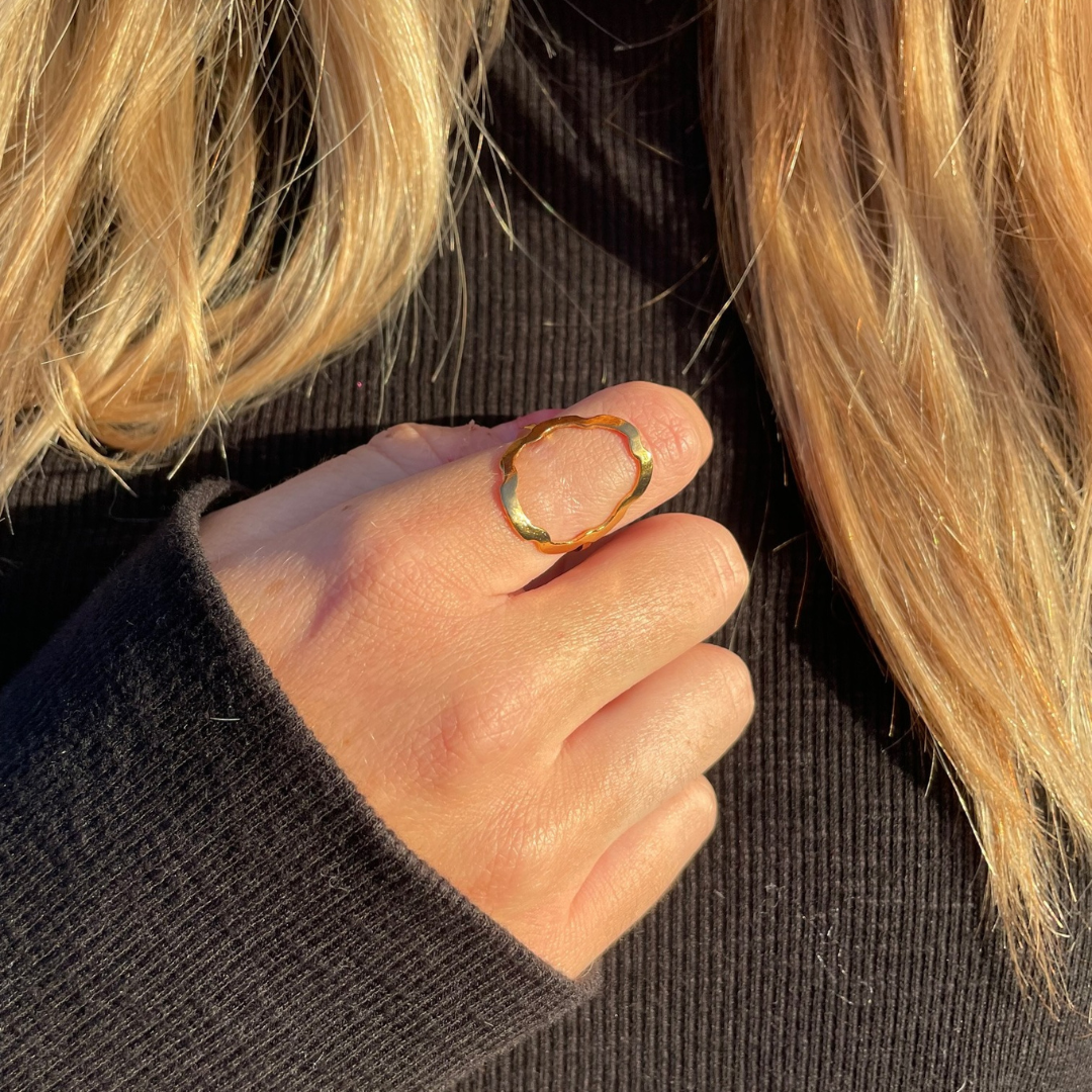 Inspired by the seven broad indentations of a euro coin and the Spanish flower, this sterling silver ring is both delicate and alluring with its fluted edges. It is tumbled for a lightly polished look and fits comfortably on the fing