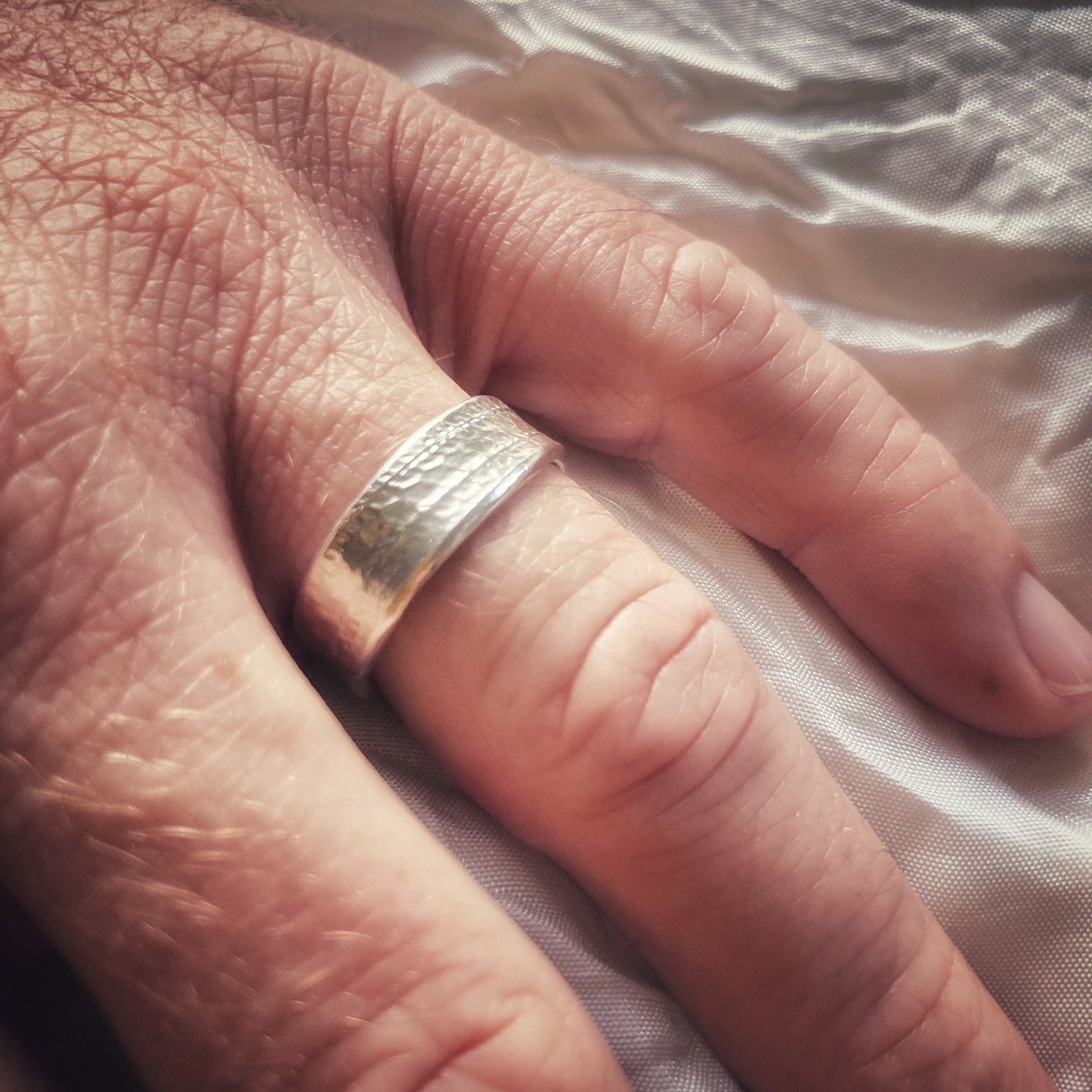 A made-to-order sterling silver design and handcrafted with a unique texture and gentle curves.  Approx. 7mm wide.  Also shown with medium mina ring.