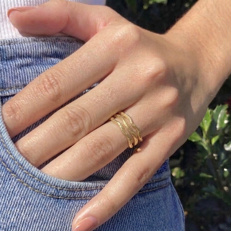 Gold fortenna sculpted rings on hand