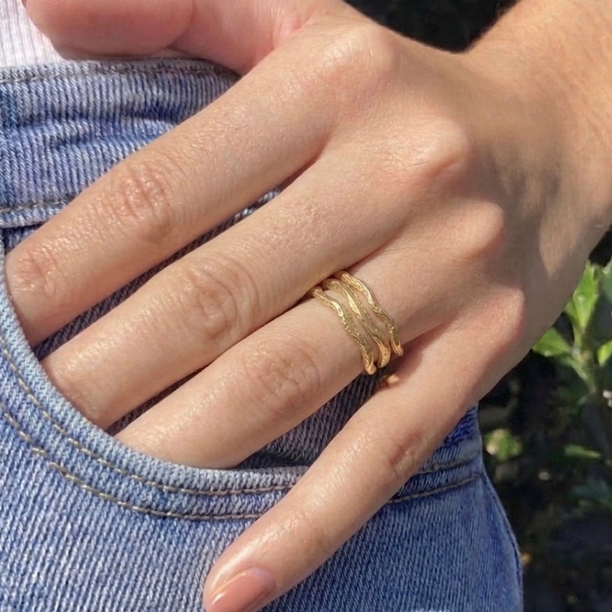 fortenna wavy gold stacking rings on hand 